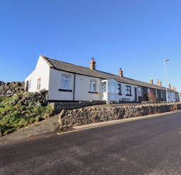 A row of houses on a street at Harry's Cottage in Embleton