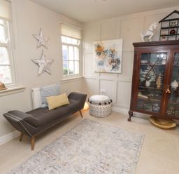 A snug with a sofa and cabinet at The Music Box in Beaumaris
