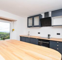 A kitchen with a sink and cabinets at Boscabrea near Tintagel
