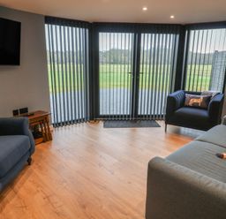 A living room with sofas and a television at Unit 2 in Ipswich
