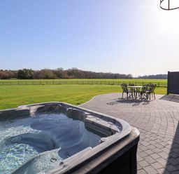 An outdoor area with a hot tub and seating at The Barley Silo in Ipswich