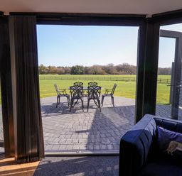 A lounge area with a view of a patio and chairs at The Barley Silo in Ipswich