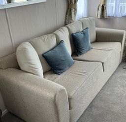 A living room with a sofa and cushions at TW89 in Exmouth