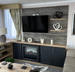 A living room with a television and fireplace at TW89 in Exmouth