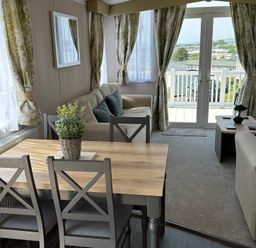 A living room with a dining area and sofa at TW89 in Exmouth