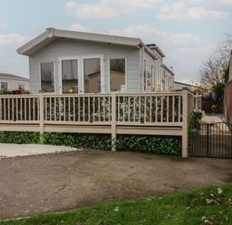 A house with a deck and gate at Offspray Court 1 Scratby