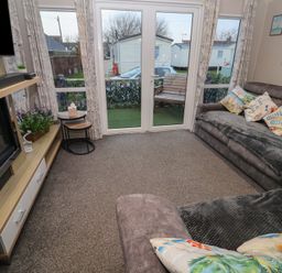 A living room with a sofa and coffee table at Offspray Court 1 Scratby