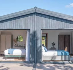 Two bedrooms with beds and wardrobes at Isca Lodge - With Decking - Lodge 1, Wombleton