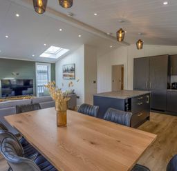 A dining room with a table and chairs at Isca Lodge in Wombleton