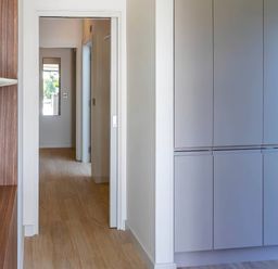 A hallway with a cabinet and a plant pot at Rye Lodge in Wombleton