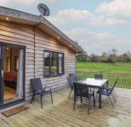 A deck with a table and chairs at Oak Lodge Admaston near Abbots Bromley