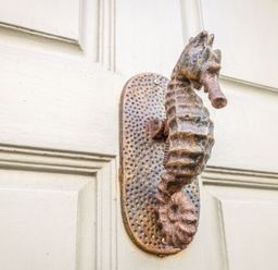 A seahorse door handle on a door at Seahorse Cottage in Weymouth