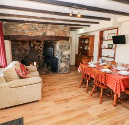 A dining room with a table and chairs at Ty Fferm in Newport
