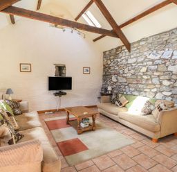 A living room with a sofa and TV at Ty Gwartheg in Newport