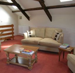 A living room with a sofa and coffee table at Ty Cariad in Newport