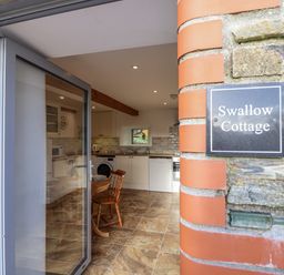 A kitchen with a table and chairs at Swallow Cottage Bullhornstone near South Brent