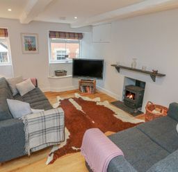 A living room with sofas and a television at The Old Workshop in 