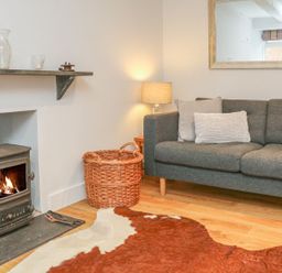 A living room with a sofa and a fireplace at The Old Workshop 