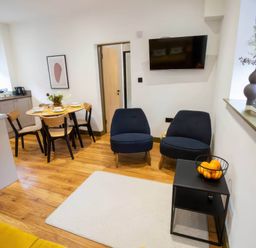 A living room with chairs and a table at Oakwood Apartment in Llanrwst