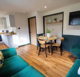 A living room with a kitchen and dining area at Ash Cottages in Llanrwst