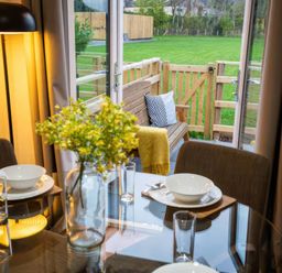 A dining room with a table and chairs at Fir Cottages in Llanrwst