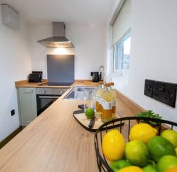 A kitchen with a sink and countertop at Fir Cottages in Llanrwst