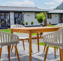 A table and chairs on a patio at Silver Birch Cottage in Llanrwst