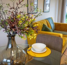 A living room with a sofa and table set at Silver Birch Cottage in Llanrwst