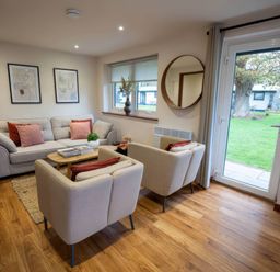 A living room with a sofa and armchairs at Mountain View Cottage in Llanrwst