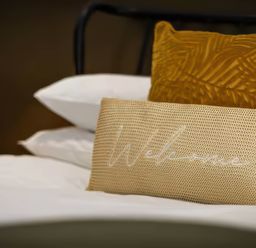 A bed with pillows in a bedroom at Mountain View Cottage in Llanrwst