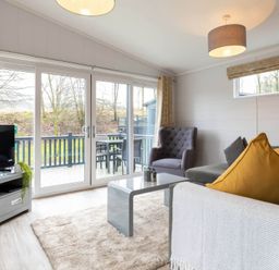 A living room with furniture and windows at The Falls in Leyburn