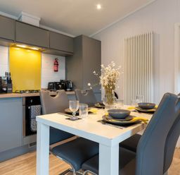 A kitchen with a dining table and chairs at The Falls in Leyburn