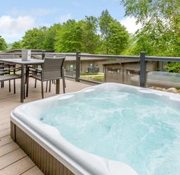 A hot tub with a table and chairs on a deck at Wensleydale (Pet) Aysgarth