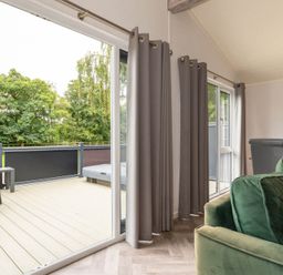 A living room with a balcony and outdoor furniture at Wensleydale (Pet) Aysgarth
