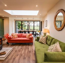 A living room with sofas and a dining area at Fairview in Darsham