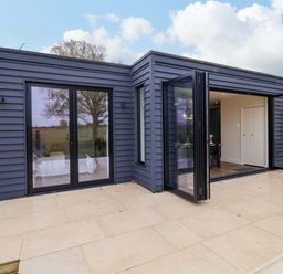 An outdoor space with sliding doors and patio tiles at Fairview in Darsham