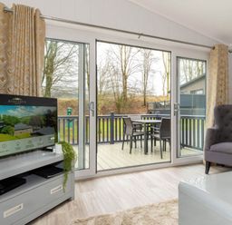 A living room with a television and sofa at The Falls (Pet) Leyburn