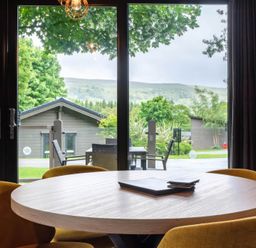 A dining room with a round table and chairs at Middleham Leyburn