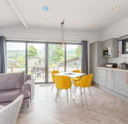 A living room with a dining area and kitchen appliances at Leyburn (Pet) Leyburn