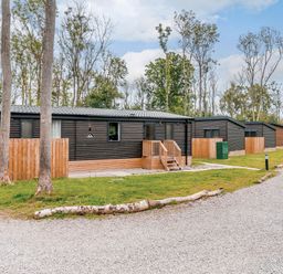 A row of lodges along a gravel drive at Anderby Spa (Pet) Louth