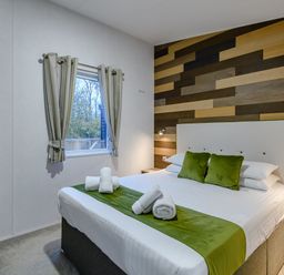 A bedroom with a bed and window at Anderby Spa (Pet) Louth