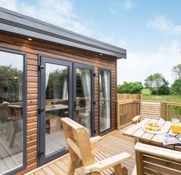 A deck with seating and a table at Caistor Spa in Louth