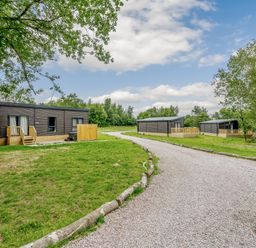 Cabins with a gravel path near trees at Horncastle Plus in Louth