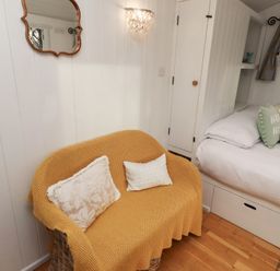 A bedroom with a sofa and a bed at Meadows in Hexham
