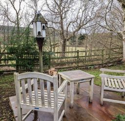 A garden area with chairs and a birdhouse at Meadows in Hexham