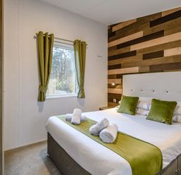A bedroom with a bed and curtains at The Kinder Spa (Pet) in Louth