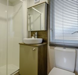 A bathroom with a shower, sink, and toilet at The Kinder Spa (Pet) Louth