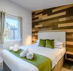 A bedroom with a bed and window at Horncastle Spa (Pet) Louth