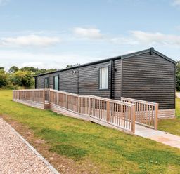 A cabin with decking on the side at Alford WF in Louth
