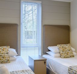 A bedroom with two beds and a window at Stamford Spa in Louth